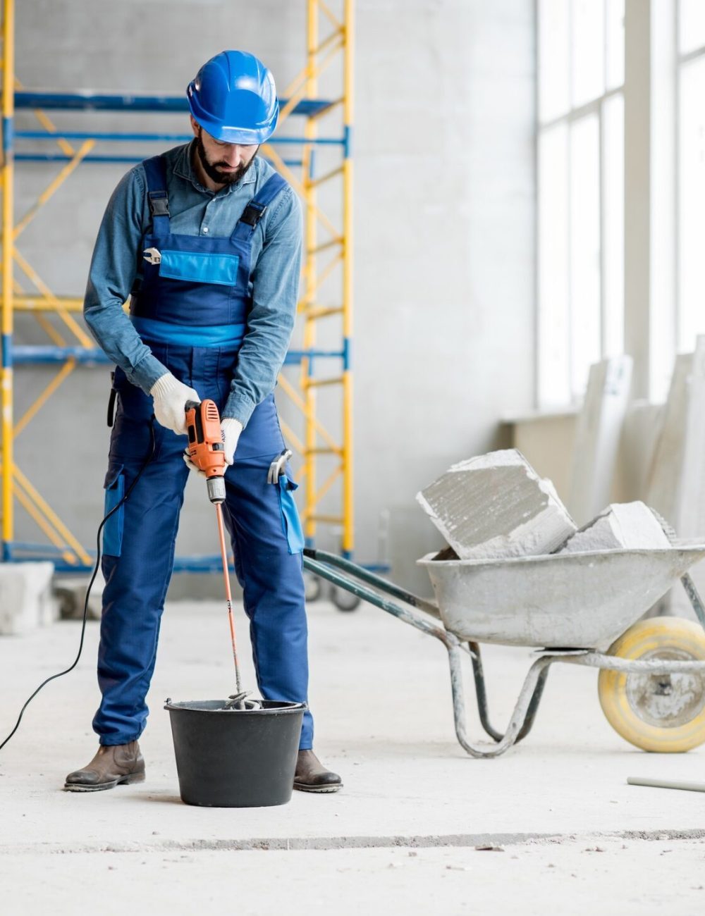 builder-mixing-plaster-at-the-construction-site.jpg